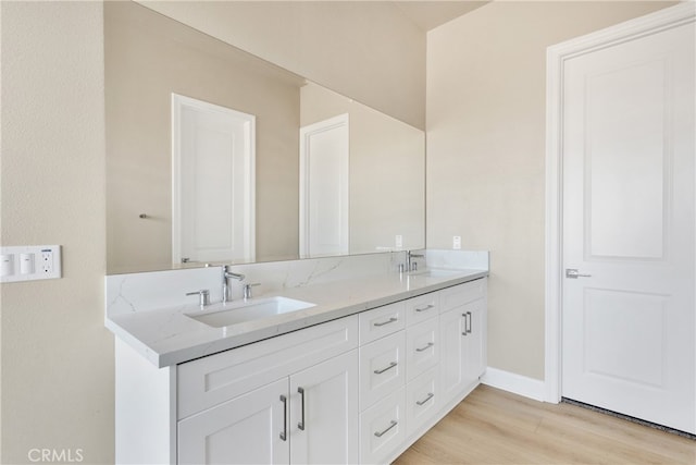 bathroom with vanity and hardwood / wood-style floors