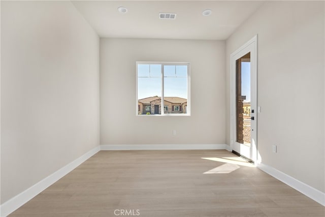 spare room with light wood-type flooring