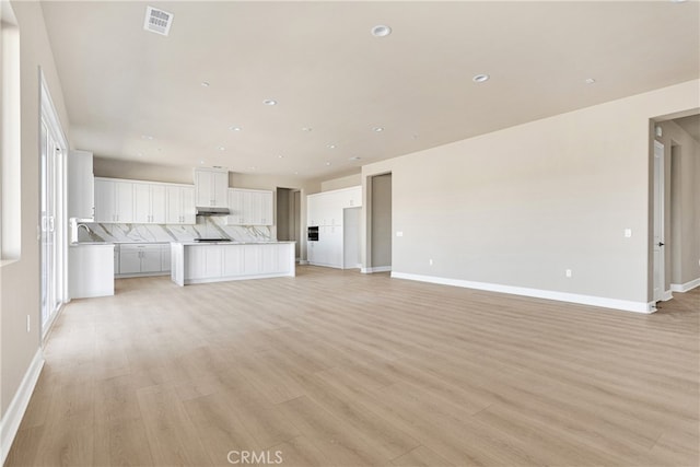 unfurnished living room with light hardwood / wood-style floors