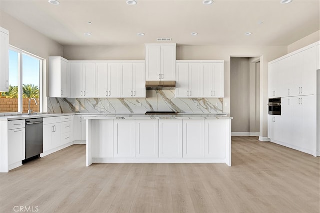 kitchen with appliances with stainless steel finishes, white cabinetry, and light wood-type flooring