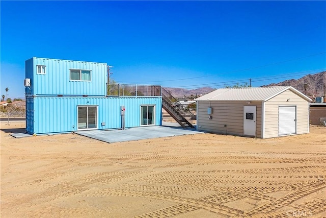 back of house with a patio area and a mountain view