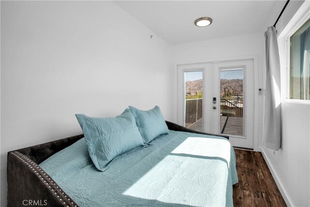 bedroom with access to outside, french doors, and dark wood-type flooring