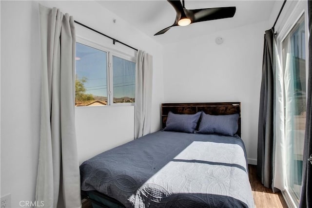 bedroom featuring hardwood / wood-style flooring and ceiling fan