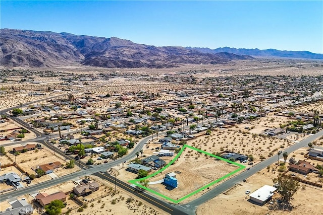 birds eye view of property with a mountain view