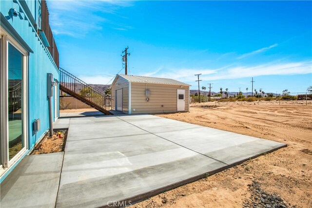 view of patio / terrace with an outbuilding and a garage