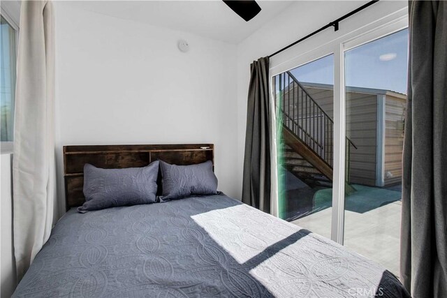 bedroom with access to exterior and ceiling fan