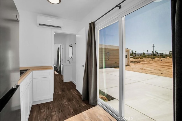 hall featuring dark wood-type flooring and a wall mounted air conditioner