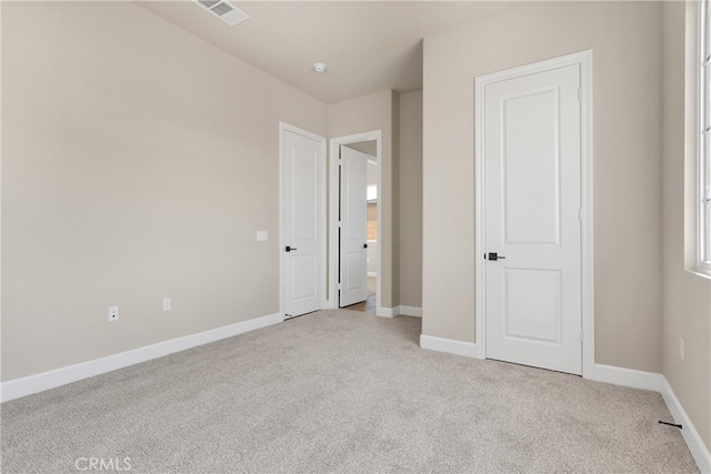 unfurnished bedroom with light colored carpet