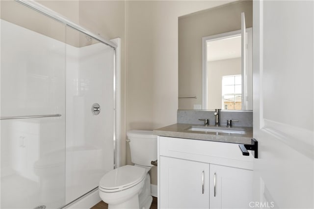 bathroom with vanity, toilet, and an enclosed shower