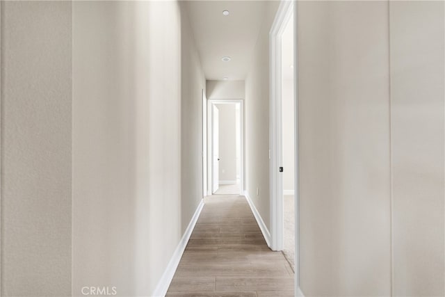 corridor with light hardwood / wood-style flooring