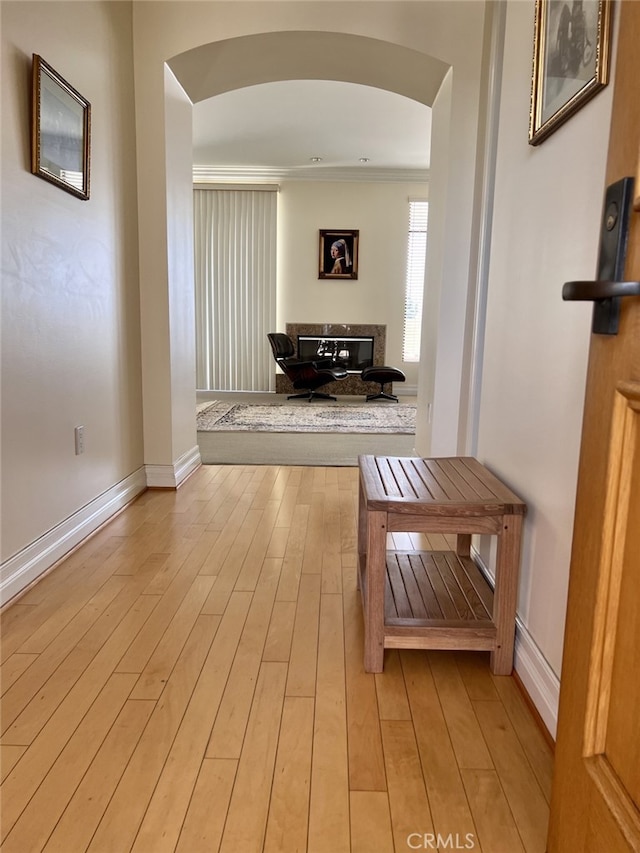 11847 Gorham Ave Unit 403, Los Angeles, CA 90049 - corridor featuring arched walkways, light wood-type flooring, and baseboards