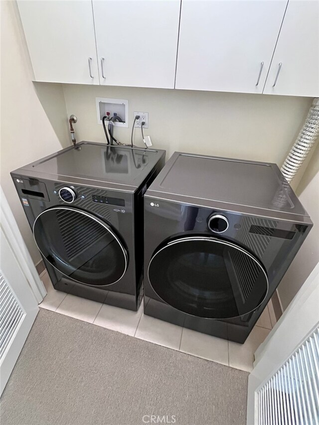 11847 Gorham Ave Unit 403, Los Angeles, CA 90049 - laundry room featuring washer and dryer, cabinet space, and tile patterned flooring