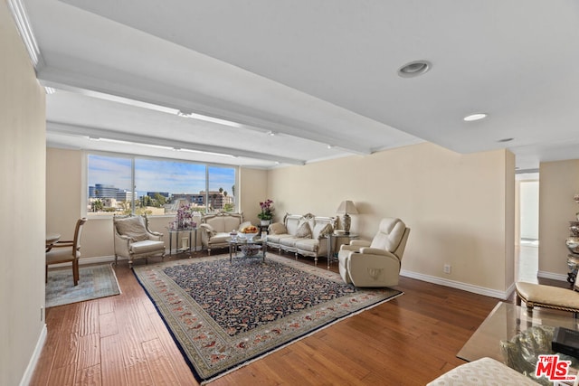 living room featuring hardwood / wood-style flooring and beamed ceiling