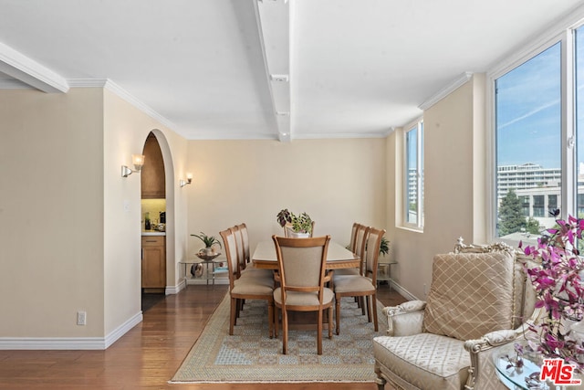 dining area featuring beam ceiling, hardwood / wood-style flooring, and ornamental molding