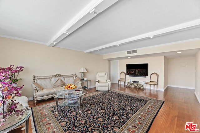 living room with wood-type flooring and ornamental molding