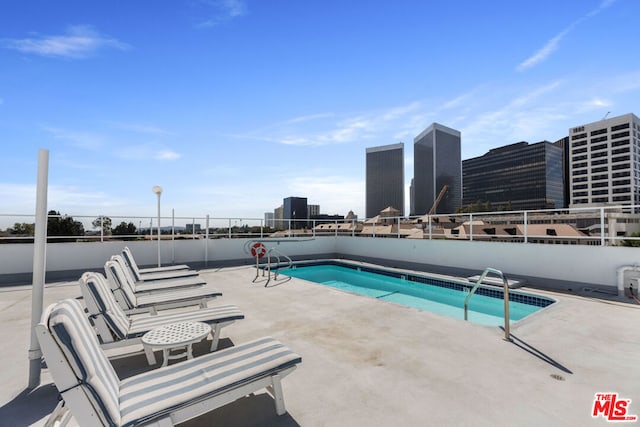 view of swimming pool with a patio area