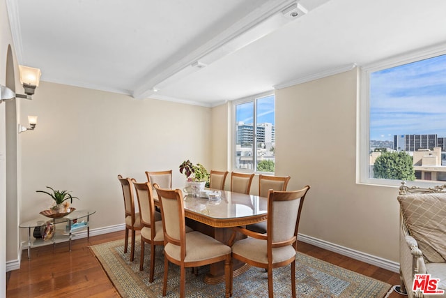 dining room with beam ceiling, ornamental molding, and dark wood-type flooring