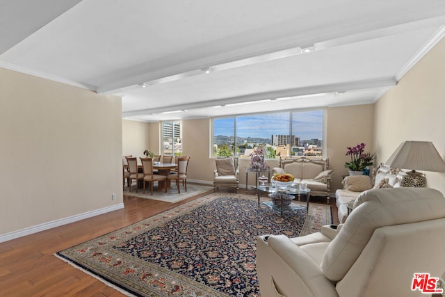 living room featuring crown molding, beamed ceiling, and hardwood / wood-style flooring