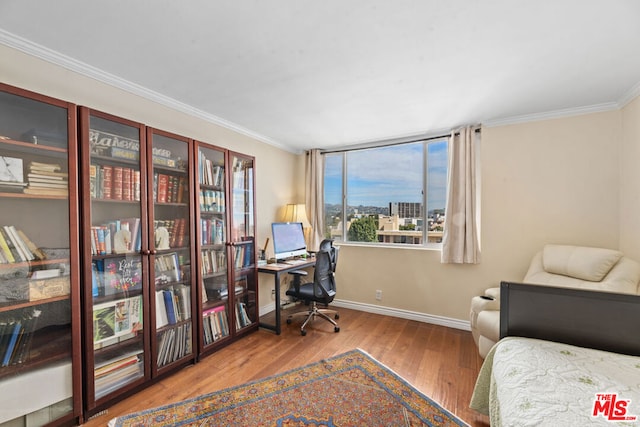 office with light wood-type flooring and crown molding