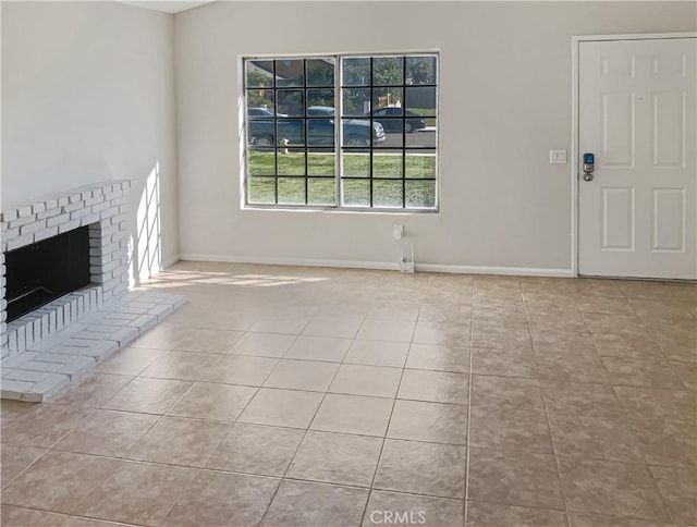 unfurnished living room featuring a fireplace and light tile patterned flooring