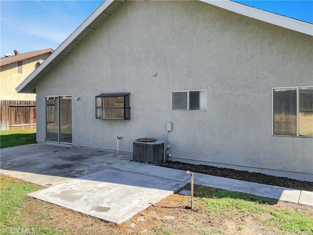 back of house with cooling unit and a patio area