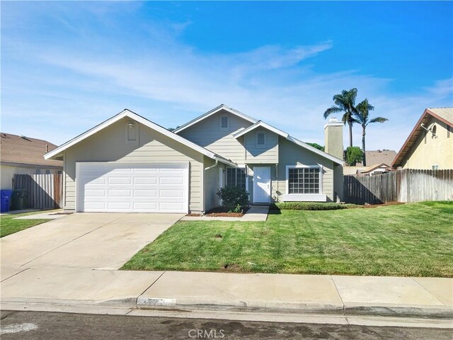 view of front of home featuring a garage and a front lawn