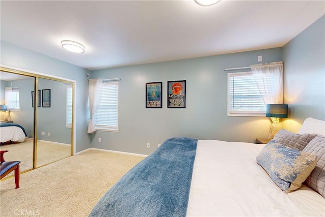 bedroom with multiple windows, carpet floors, and a closet