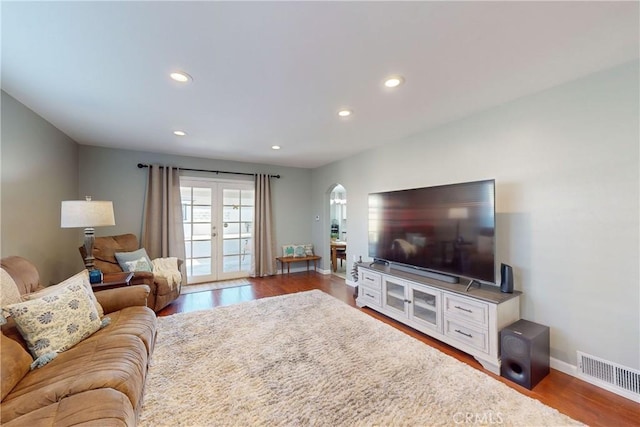 living room featuring french doors and dark wood-type flooring