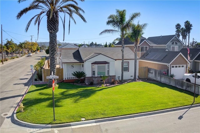 view of front of home featuring a garage and a front lawn