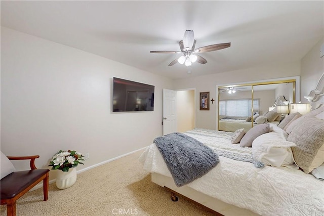 carpeted bedroom featuring ceiling fan and a closet