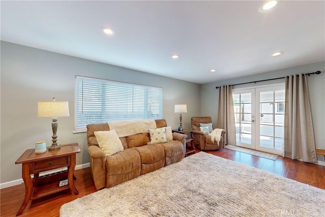 living room with dark hardwood / wood-style flooring and french doors