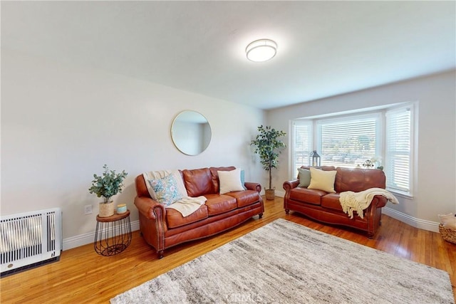 living room with hardwood / wood-style floors and heating unit