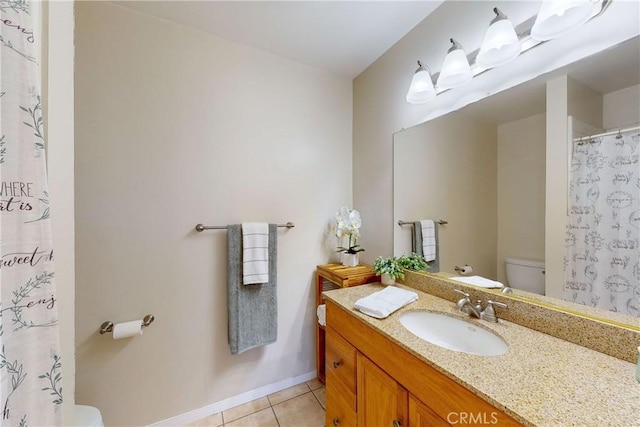 bathroom with tile patterned floors, vanity, and toilet