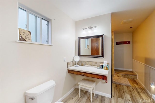 bathroom featuring wood-type flooring and toilet