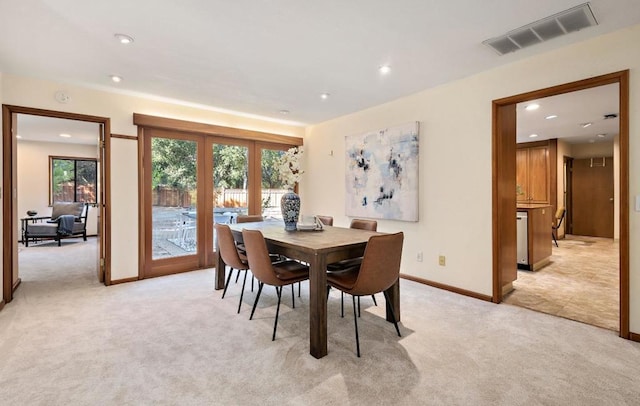 dining space featuring light colored carpet