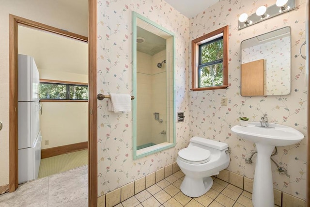 bathroom with tub / shower combination, tile patterned flooring, and toilet