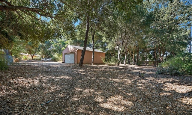 view of yard with a garage and an outdoor structure