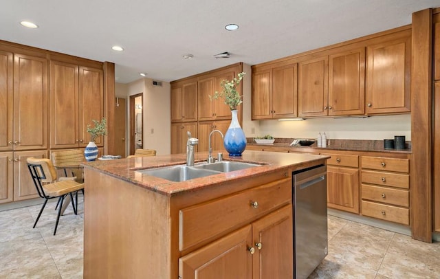 kitchen featuring stainless steel dishwasher, a kitchen island with sink, stone countertops, and sink