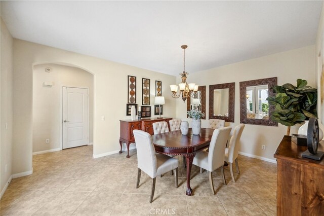 tiled dining area featuring a notable chandelier