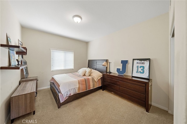 bedroom with baseboards and light colored carpet