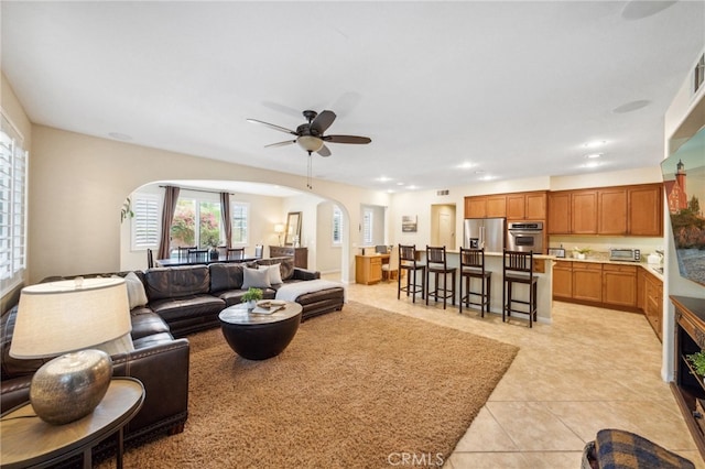 tiled living room featuring ceiling fan