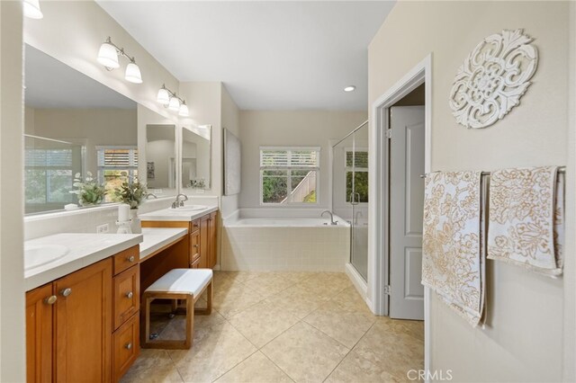 bathroom featuring plus walk in shower, tile patterned floors, and vanity