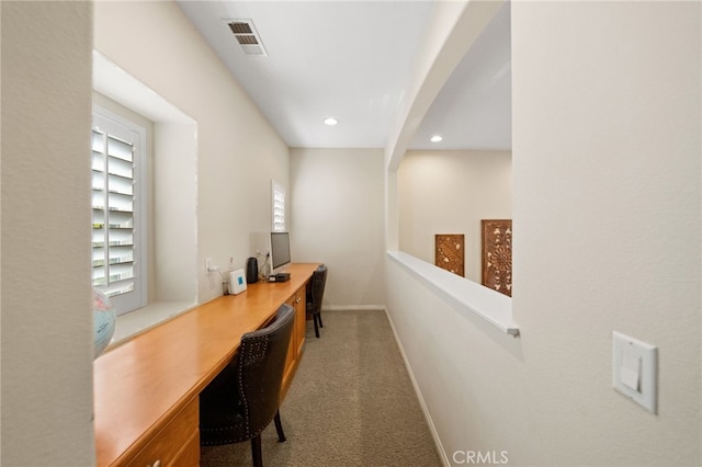 carpeted office with recessed lighting, visible vents, built in desk, and baseboards