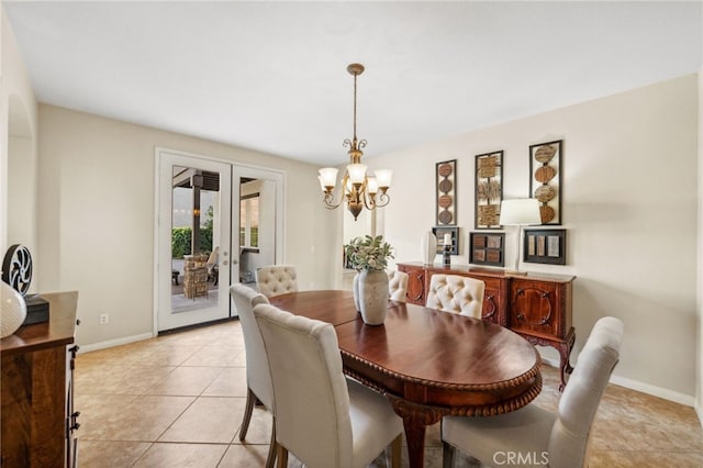 tiled dining space featuring a chandelier