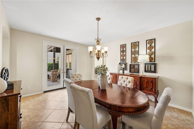 dining space featuring a chandelier, baseboards, and light tile patterned floors