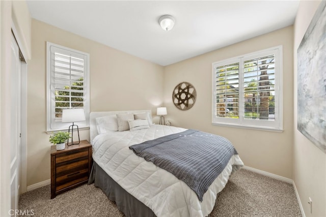 bedroom with carpet and baseboards