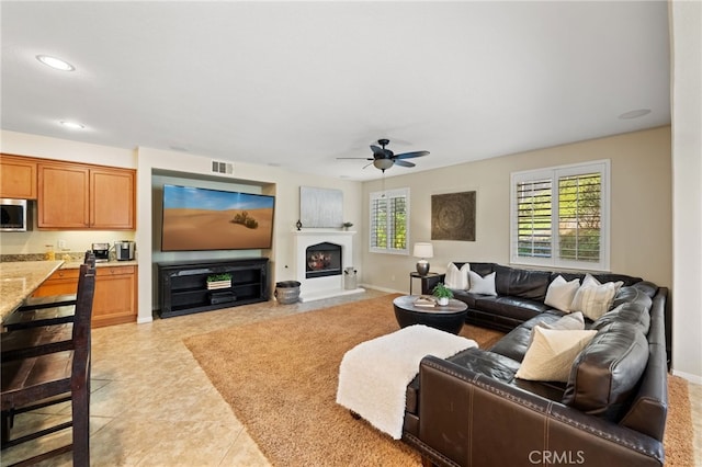 living room with ceiling fan and light tile patterned floors