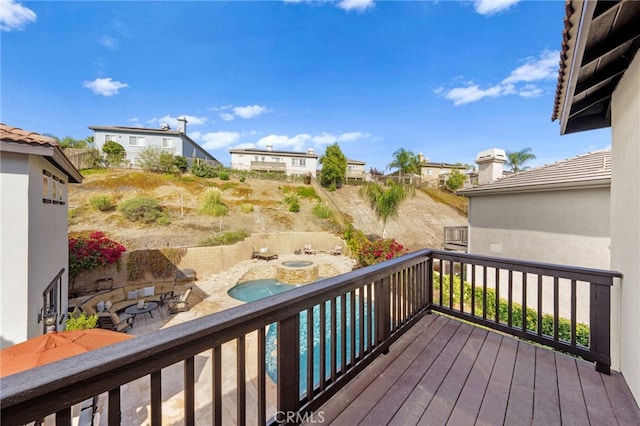 wooden terrace with a fenced in pool