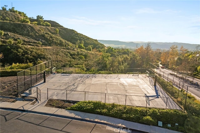 exterior space featuring fence and a mountain view