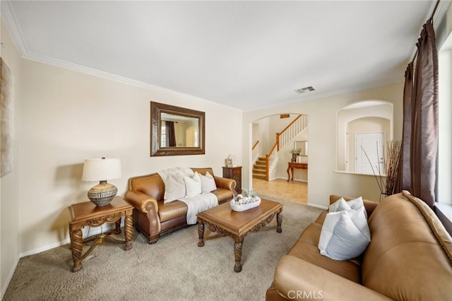 living area with arched walkways, crown molding, visible vents, stairway, and carpet flooring